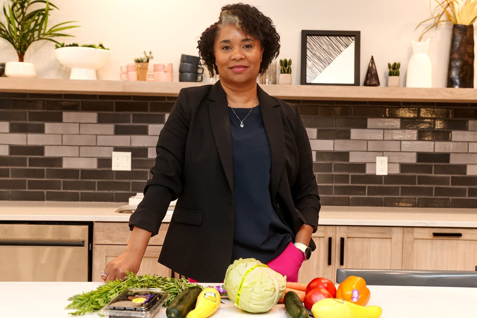 KaTrina Samuels-Garrison preparing fresh produce at a kitchen counter